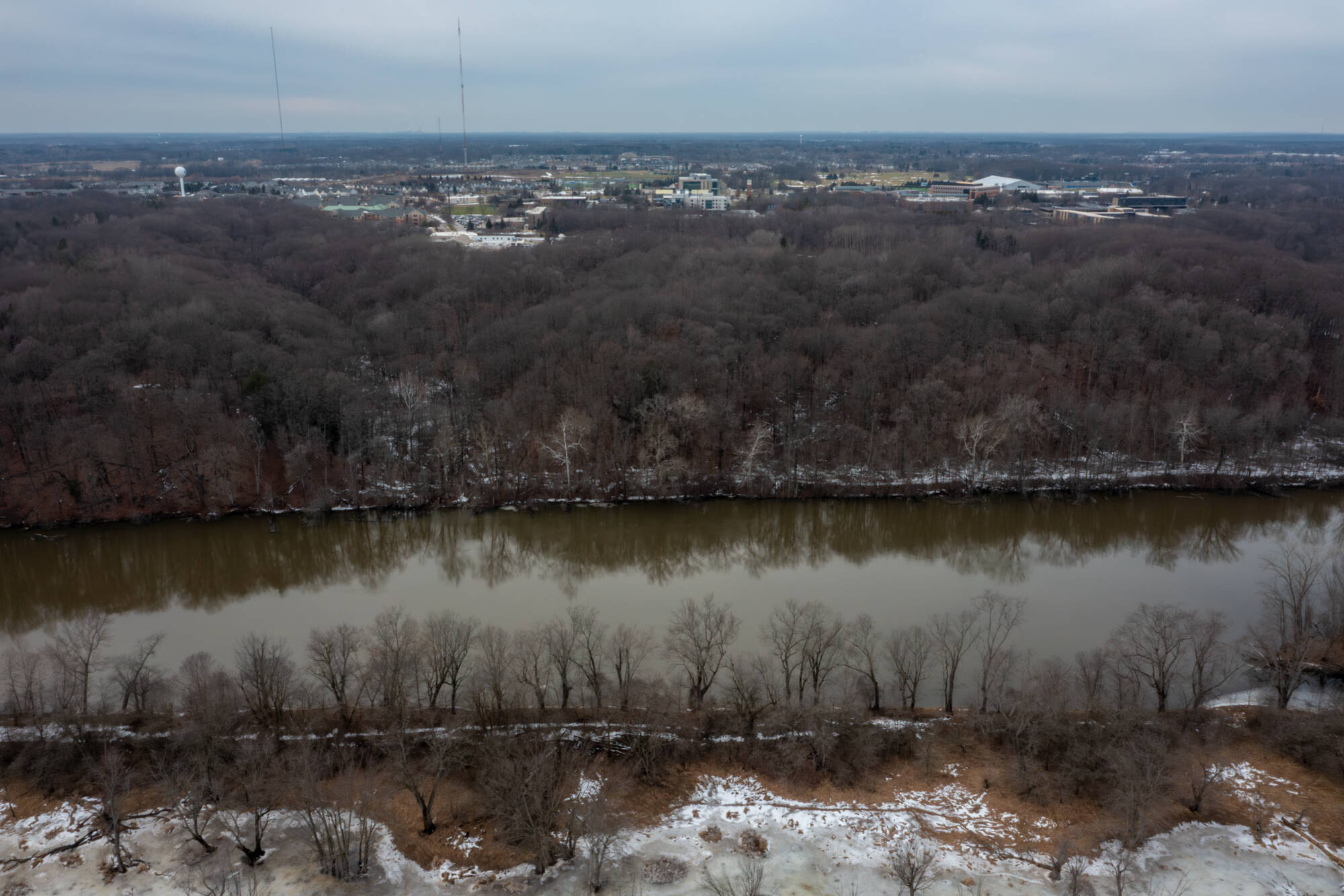 Aerial view of the grand river running through the ravines on a snowy day